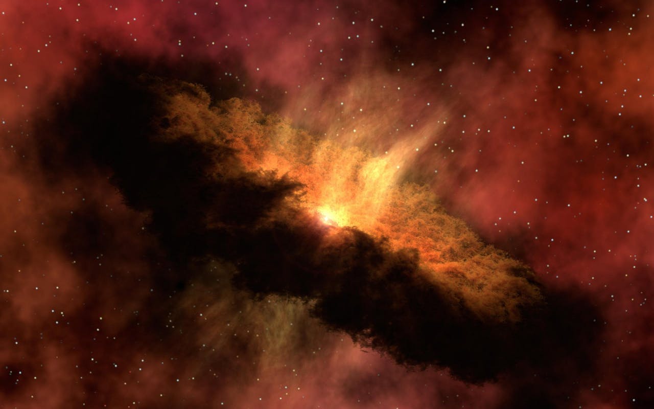 A glowing orange and yellow nebula surrounded by dark clouds of gas and dust floats in space, with numerous small white stars scattered in the background.